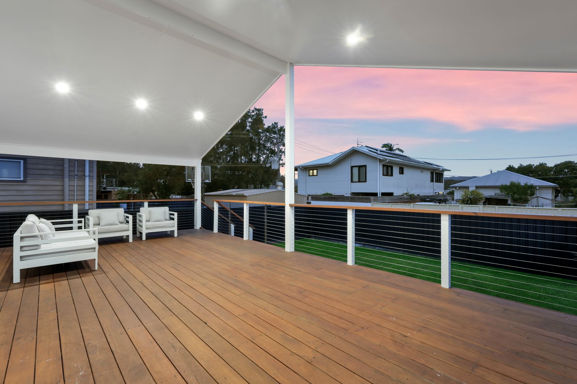 Wide covered deck with wire balustrade